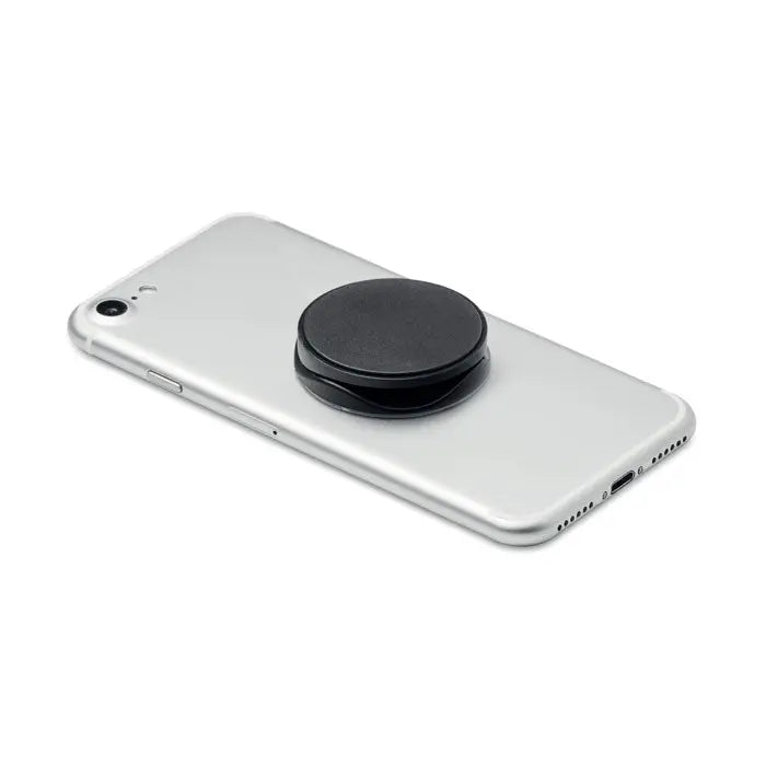 Suport rotund pentru telefon negru din plastic atasat pe partea din spate a unui smartphone argintiu