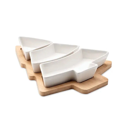 Tava de servire pentru pomul de Craciun din ceramică albă în formă de pom aranjată pe tocător de lemn deschis