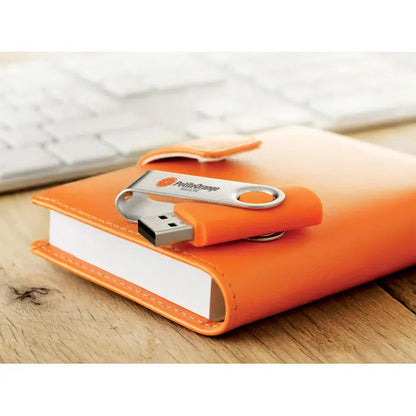 Notebook portocaliu din piele cu stick usb argintiu si portocaliu techmate usb flash de 4 gb pe coperta